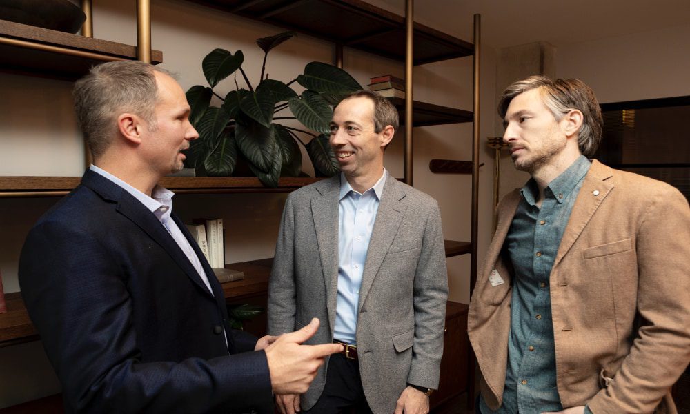 Three men talking