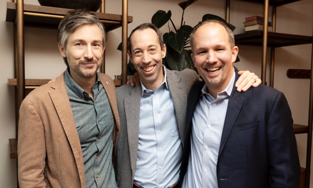 three smiling businessmen