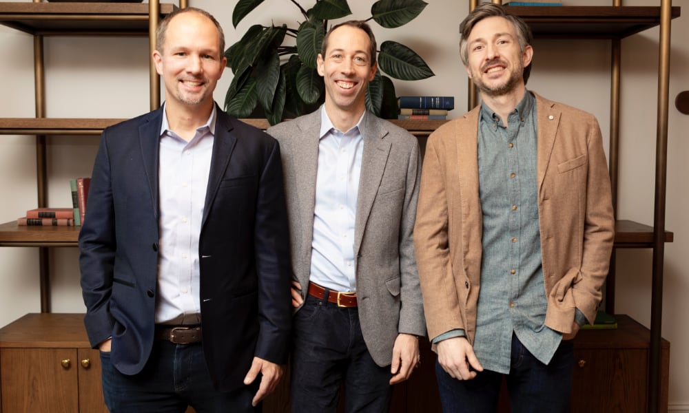 three men smiling